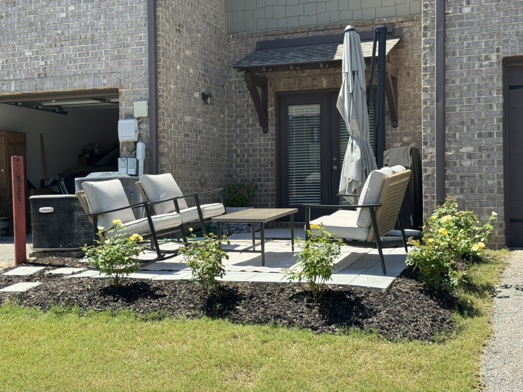 Inviting outdoor escape with conversation set and knockout roses surrounding a patio
